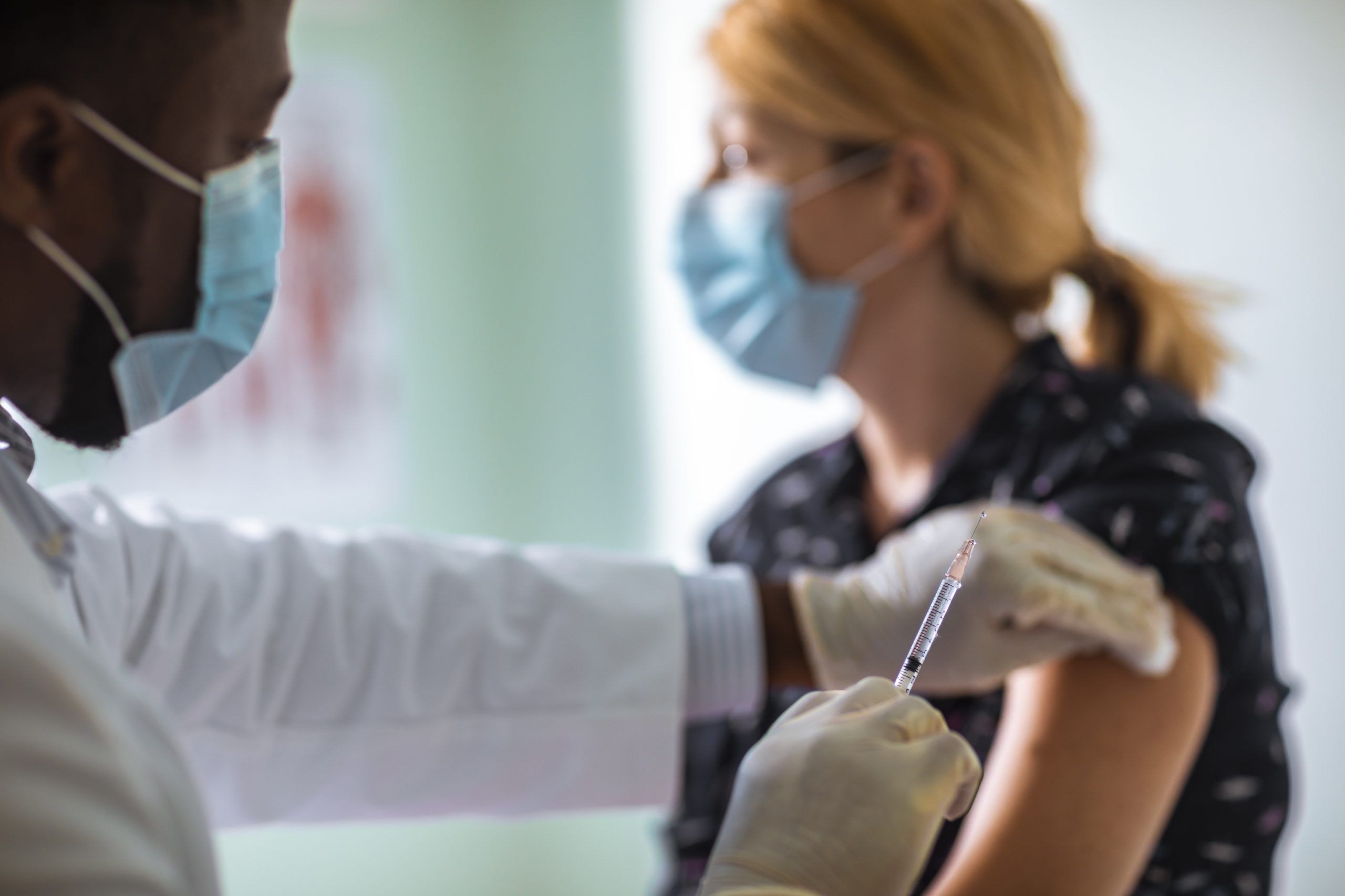 Close up of a young woman getting vaccinated